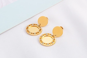 Makroaufnahme goldener Ohrringe mit römischen Ziffern und polierter Metalloberfläche