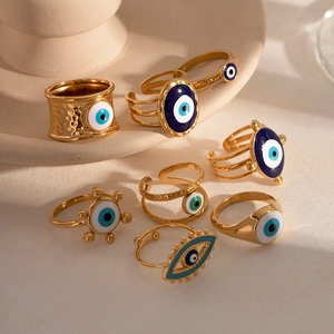 Vintage gold evil eye enamel rings collection for women on elegant ceramic dish