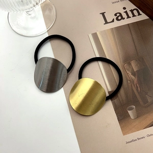 Set of two minimalist elastic hair ties with brushed gold and silver metal round plates