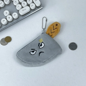 Close-up of a clever plush meat cleaver coin purse with funny facial embroidery