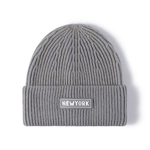 Grey knit beanie with New York label, soft ribbed fabric, stylish outdoor winter hat