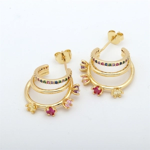 Detailed macro view of gold-plated multi-layer C-shape earrings with rainbow zircons