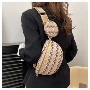 Detailed view of wave-pattern woven waist bag with round coin purse and wide strap on suit