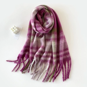 Close-up of pink and green plaid mohair scarf with soft fuzzy texture and fringe tassels