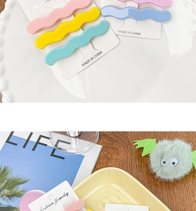 Detail showing wavy matte macaron hair clips and a cute plush monster hair clip