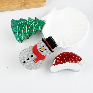 Christmas hair claw set with acrylic Santa hat, glitter tree, and snowman accessories