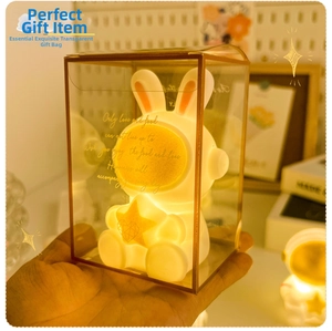 Close-up of a glowing bunny astronaut night light in a stylish gift bag with warm light