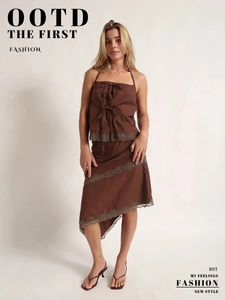 Detail of dark brown camisole and lace-trimmed midi skirt set with ruffled hem