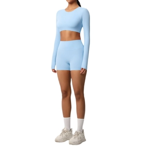 Women's light blue yoga set with long sleeve crop top and high waist sports shorts