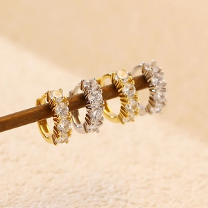 Detail showing gold and silver S925 sterling silver hoop earrings with inlaid zircons