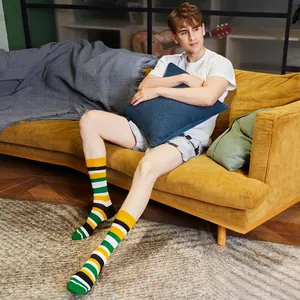 Striped mid-calf crew socks for men and women featuring green, yellow, and black colors