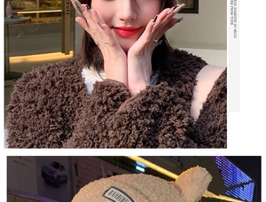 Close-up of soft plush lamb wool hat with cute bear ears and stylish letter patch