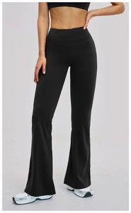Detail of high-waist flared yoga pants and sports top in matte black elastic fabric