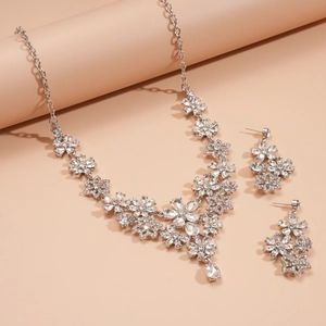Detailed view of luxury silver flower necklace and earrings set with sparkling crystals