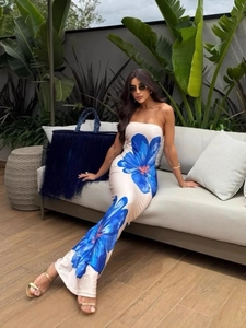 Sleeveless off-shoulder cream maxi dress with vibrant blue floral patterns for beach vacation