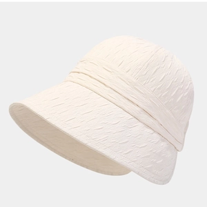 Foldable beige sun hat with textured fabric and wide brim for stylish sun protection