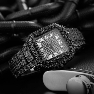 Macro detail of iced-out square watch with Roman numerals and full diamond-set black metal