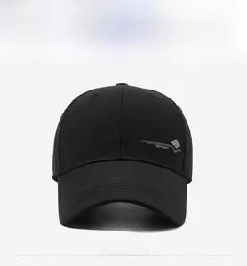 Close-up of a black baseball cap featuring a silver metal SPORT tag on the side panel