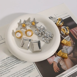 Variety of vintage gold and silver stainless steel earrings with pearl and star designs