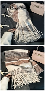 Detail of soft striped knit scarf with long tassels in beige, brown and grey tones