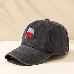 Detail of Texas map embroidery on a washed black cotton baseball cap with classic texture