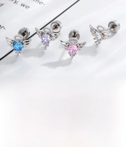 Macro view of titanium steel angel wing cartilage studs with colorful zircon stones