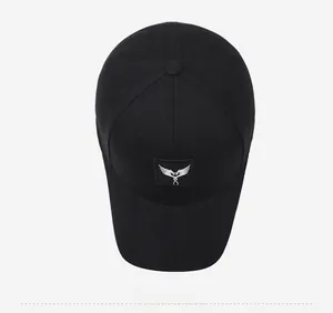 Top down view of black cotton baseball cap with embroidered logo and classic six panel design