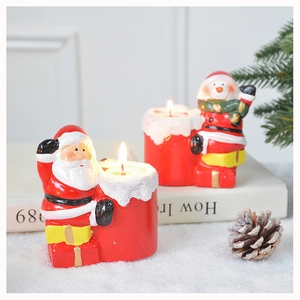 Close-up of Santa Claus and snowman candles for festive Christmas dinner table decor