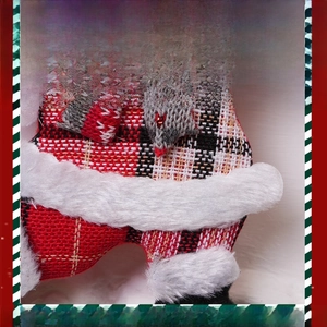 Macro detail of Christmas plush ornament showing fine stitching and grey knit textures