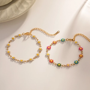 Detail of colorful daisy charm bracelets with gold finish and adjustable lobster clasp