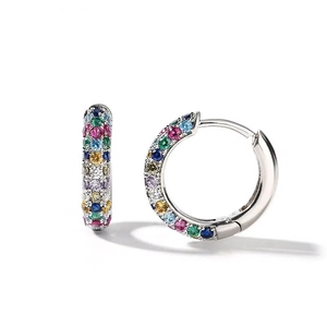 Detail of huggie earrings with colorful round-cut gemstones in a rainbow pattern