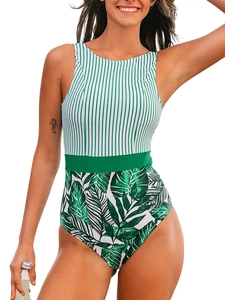 Detailed view of the striped and tropical leaf print pattern on a women's one-piece swimsuit