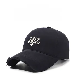 Detailed close-up of distressed brim and 3D white embroidery on black cotton baseball cap