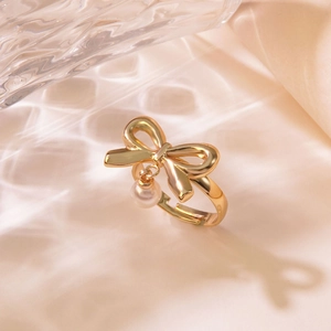 Elegant gold bow ring with hanging pearl pendant and adjustable band for women