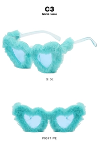 Detail of heart-shaped sunglasses with mint blue plush fur frame and tinted lenses