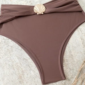 Detailed close-up of dark brown high-waisted bikini bottoms with gold shell buckle decor