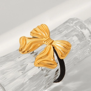 18K gold plated stainless steel bow hair tie with textured finish on white background