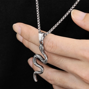 Vintage silver snake pendant necklace with detailed scales on a long metal chain