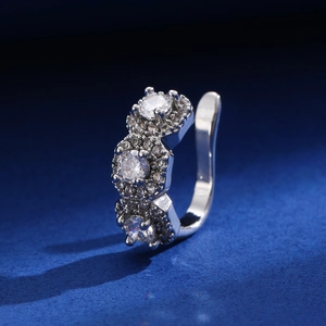 Macro detail of silver ear cuff with three hexagonal zircon clusters and micro-pave stones
