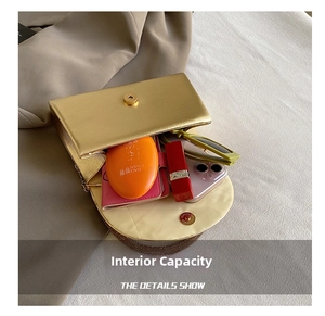 Detail view of gold chain crossbody bag showing capacity for phone, lipstick and sunglasses