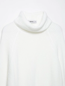 Detail shot of the white high neck knit sweater with vertical ribbed texture and size label