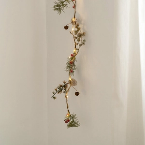 LED Christmas string light with pine cones, red berries and needles on hemp rope