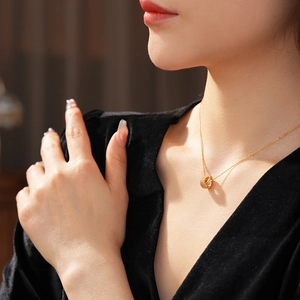 Detail view of 18K gold plated double interlocking rings necklace with sparkling zircon pavé