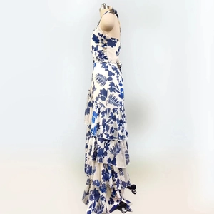 Detail view of tiered ruffle hem on blue and white tropical floral maxi dress
