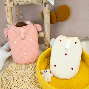 Detail of pink and beige quilted pet vests with heart embroidery and leash D-ring