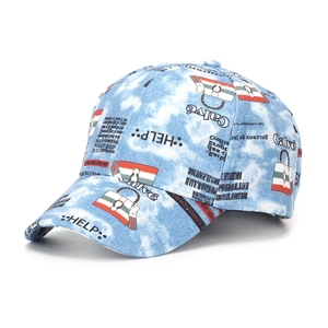 Detail of blue tie-dye denim baseball cap featuring graffiti and newsprint pattern