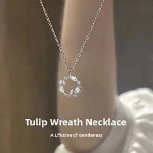 Detailed view of 925 silver tulip wreath necklace with white zircon stones on a model