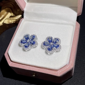 Vintage blue zircon flower stud earrings displayed in a luxury pink velvet jewelry box