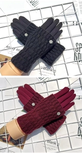 Close-up of winter gloves in dark grey and wine red with knit cuffs and floral accents