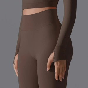 Detail of seamless coffee brown high waist yoga leggings and long sleeve thumbhole top